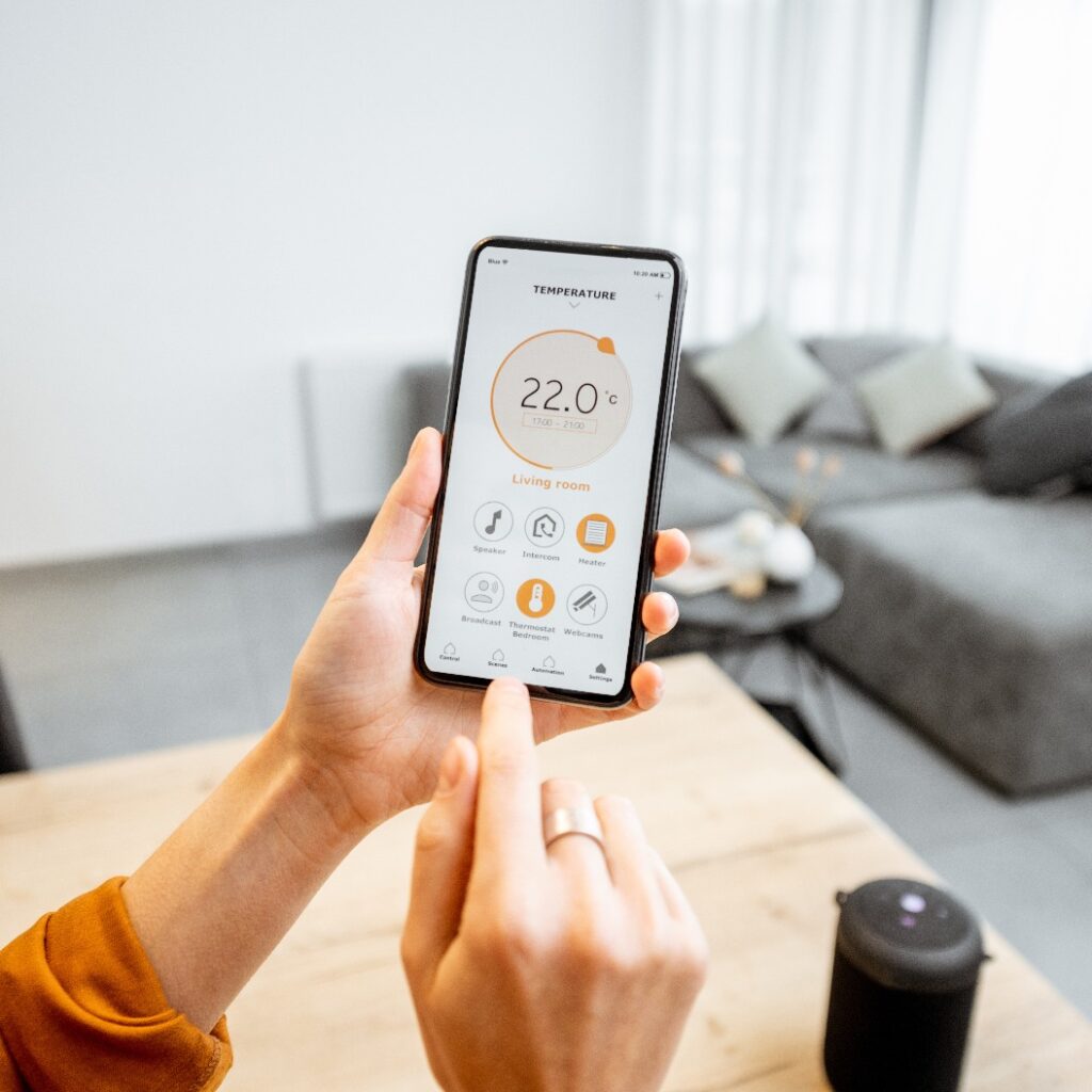 Controlling home heating temperature with a smart home, close-up on phone. Concept of a smart home and mobile application for managing smart devices at home